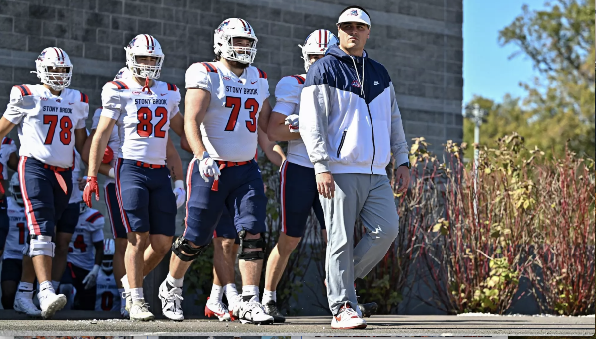 Head Coach Billy Cosh walking out with the Stony brook Football team.

Photo Courtesy of stonybrookathletics.com